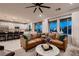 Open-concept living room featuring stylish leather sectional sofa and view to kitchen at 12053 Arrebol Ave, Las Vegas, NV 89138