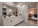 Elegant main bathroom with double vanity, large mirrors, and stylish tile flooring at 12053 Arrebol Ave, Las Vegas, NV 89138