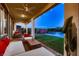 Covered patio with comfortable seating, ceiling fans, and a view of the pool and backyard at 12053 Arrebol Ave, Las Vegas, NV 89138