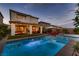 Inviting backyard oasis featuring a sparkling pool, spa, and covered patio with outdoor seating at 12053 Arrebol Ave, Las Vegas, NV 89138