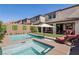 Private backyard oasis with a pool, spa, outdoor seating, and a beautifully landscaped area at 12053 Arrebol Ave, Las Vegas, NV 89138