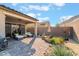 Backyard view featuring desert landscaping, inviting covered patio with seating, perfect for relaxation at 12843 New Providence St, Las Vegas, NV 89141