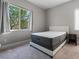 This bedroom features a window with a view of trees and carpet flooring at 12843 New Providence St, Las Vegas, NV 89141