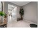 Neutral hallway with porcelain tile floor, white doors, and faux tree decor at 12843 New Providence St, Las Vegas, NV 89141