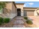 Close-up of front entry with brick pathway, lovely landscaping and modern stucco facade at 12843 New Providence St, Las Vegas, NV 89141