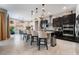 A stylish kitchen, dining, and living space featuring tile flooring, modern appliances, and lots of light at 12843 New Providence St, Las Vegas, NV 89141