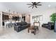 Open-concept living room featuring tile flooring, modern furnishings, and seamless access to the kitchen at 12843 New Providence St, Las Vegas, NV 89141