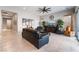 Spacious living room with tile flooring, comfortable leather furniture, and abundant natural light at 12843 New Providence St, Las Vegas, NV 89141