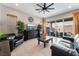 Spacious living room with a ceiling fan, tile flooring, access to the patio and backyard at 12843 New Providence St, Las Vegas, NV 89141