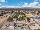 Expansive aerial view showcasing a neighborhood with mature landscaping and a distant city skyline at 131 Beesley Dr, Las Vegas, NV 89110