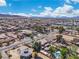 An aerial perspective of a neighborhood with mountain views, showcasing the layout of homes and streets at 131 Beesley Dr, Las Vegas, NV 89110