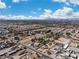 Expansive aerial view of a residential neighborhood with city skyline and mountain backdrop under a bright, blue sky at 131 Beesley Dr, Las Vegas, NV 89110