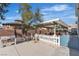 Cozy backyard seating area with a charming white picket fence and mature trees at 131 Beesley Dr, Las Vegas, NV 89110