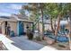 Charming backyard retreat with unique blue accents, a cozy den, and lush landscaping creating a serene oasis at 131 Beesley Dr, Las Vegas, NV 89110