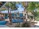 Relaxing backyard with a swing, mature trees, and colorful accents, perfect for outdoor enjoyment at 131 Beesley Dr, Las Vegas, NV 89110