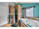 Bathroom featuring tile flooring, soaking tub, walk-in shower, and a large window at 131 Beesley Dr, Las Vegas, NV 89110