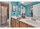 Bathroom features a double sink vanity with wood cabinets, blue walls, and shower with curtain at 131 Beesley Dr, Las Vegas, NV 89110