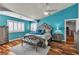 Bedroom with turquoise walls, plantation shutters, and decorative furniture at 131 Beesley Dr, Las Vegas, NV 89110