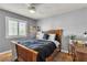 Comfortable bedroom featuring a wood frame bed, a ceiling fan, and natural light from the window at 131 Beesley Dr, Las Vegas, NV 89110