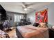Cozy bedroom featuring a ceiling fan, window, and unique decor, offering a comfortable and personal space at 131 Beesley Dr, Las Vegas, NV 89110