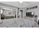Bedroom features mirrored closet doors, gray walls, wood-look flooring, and TV at 131 Beesley Dr, Las Vegas, NV 89110