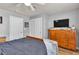 Spacious bedroom showcases natural wood furniture, including a dresser, complemented by neutral gray walls at 131 Beesley Dr, Las Vegas, NV 89110