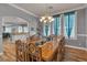 Bright dining room featuring a large dining table, chandelier, and three windows at 131 Beesley Dr, Las Vegas, NV 89110