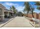 Long driveway leading to a beautifully landscaped backyard with a covered outdoor kitchen at 131 Beesley Dr, Las Vegas, NV 89110