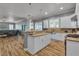 Open-concept kitchen with a large island, modern appliances, and wood flooring at 131 Beesley Dr, Las Vegas, NV 89110