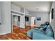 Living room featuring an open floor plan, blue sofa, and wood-look flooring at 131 Beesley Dr, Las Vegas, NV 89110