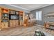 Inviting living room features custom built-ins, entertainment center, hardwood floors, and a charming bar area at 131 Beesley Dr, Las Vegas, NV 89110