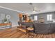 Comfortable living room with wood floors, a ceiling fan, and a built-in shelving unit at 131 Beesley Dr, Las Vegas, NV 89110