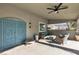 Outdoor covered patio area offers comfortable seating, ceiling fan, and view of the backyard at 131 Beesley Dr, Las Vegas, NV 89110