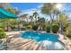 Refreshing pool with mature landscaping and a covered area for relaxing on a sunny day at 131 Beesley Dr, Las Vegas, NV 89110