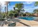Inviting pool area surrounded by lush greenery, with a cozy seating and a covered gazebo at 131 Beesley Dr, Las Vegas, NV 89110