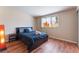 Cozy bedroom with wood-look floors and a window that offers plenty of natural light at 1615 Palora Ave, Las Vegas, NV 89169