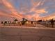 Ranch style home with gated entrance and landscaped front yard at sunset at 1615 Palora Ave, Las Vegas, NV 89169