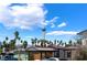 Exterior view of building with palm trees under cloudy sky, showing the Stratosphere at 1615 Palora Ave, Las Vegas, NV 89169