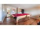 Game room with pool table and hardwood floors at 1615 Palora Ave, Las Vegas, NV 89169