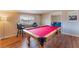 Spacious game room with a pool table and bar seating at 1615 Palora Ave, Las Vegas, NV 89169