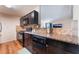 Galley kitchen with granite countertops, dark cabinetry, and stainless steel appliances at 1615 Palora Ave, Las Vegas, NV 89169