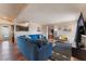 Living room with hardwood floors, sectional couch, and flat screen tv at 1615 Palora Ave, Las Vegas, NV 89169