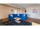 Well-lit living room with sectional couch and hardwood floors at 1615 Palora Ave, Las Vegas, NV 89169