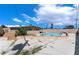 Backyard with pool surrounded by a spacious patio and desert landscape at 1615 Palora Ave, Las Vegas, NV 89169