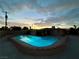 Private backyard pool surrounded by patio space during dusk at 1615 Palora Ave, Las Vegas, NV 89169