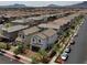 An aerial view of a neighborhood showcasing rooftops and street layout with mountain views in the distance at 169 Volti Subito Way, Henderson, NV 89011