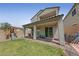 Grassy backyard with patio, play equipment, and privacy fence for outdoor enjoyment at 169 Volti Subito Way, Henderson, NV 89011
