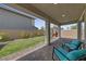 Covered patio with brick flooring, lawn and landscaped garden at 169 Volti Subito Way, Henderson, NV 89011