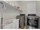 Functional laundry room with modern appliances, including a washer and dryer, and storage space for supplies at 169 Volti Subito Way, Henderson, NV 89011
