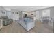 Open concept living room flowing into a bright kitchen with an island and modern appliances at 169 Volti Subito Way, Henderson, NV 89011